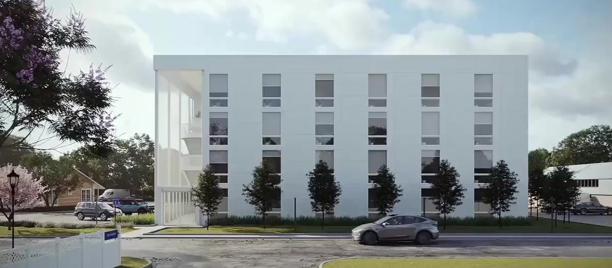A rendered street view of a Vessel apartment building: white modular facade above a parked car and young trees