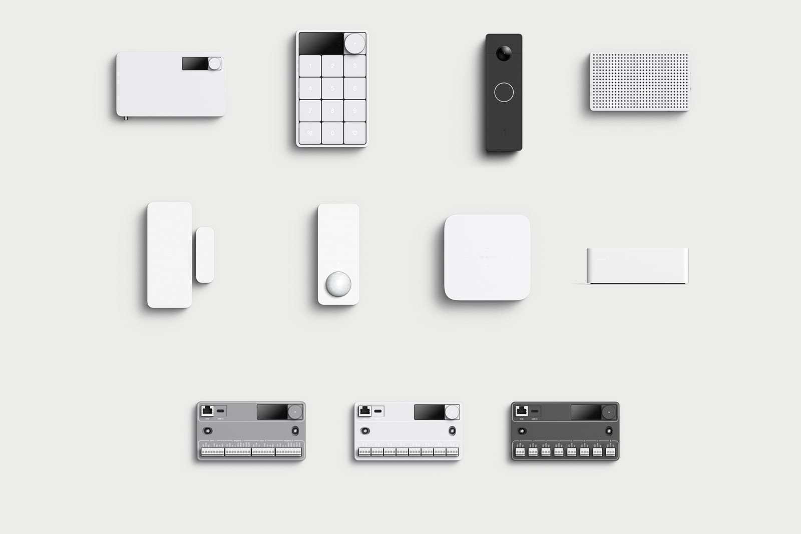 The Simple Things device family on a neutral ground: hub, keypad, doorbell, chime, entry sensor, motion and radar sensors, power bank, and the access, input, and output building modules