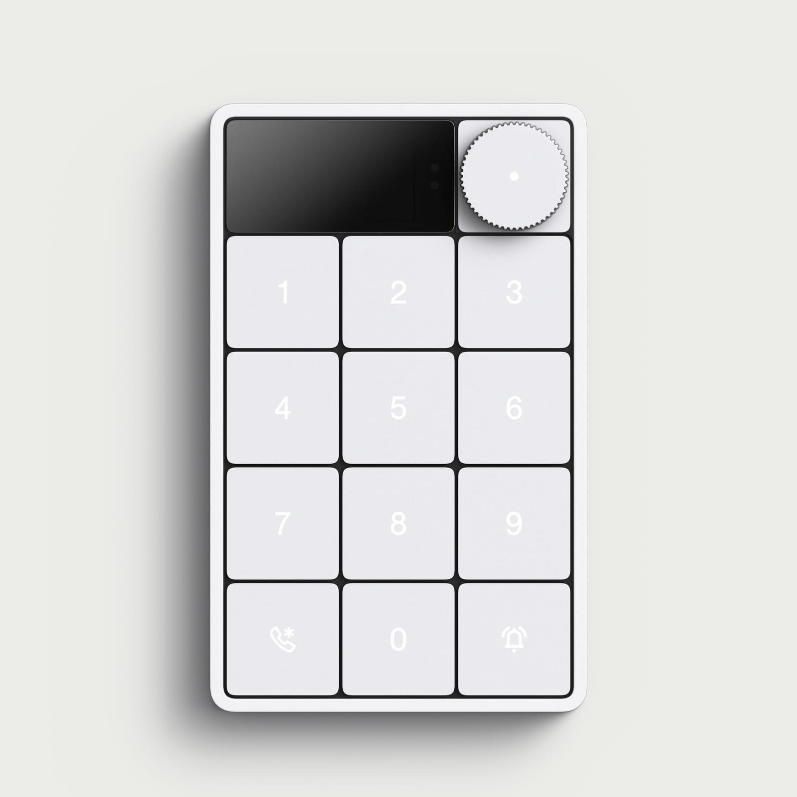 The Simple Things keypad, a white wall unit with a black display, a ridged dial, and a twelve-key pad