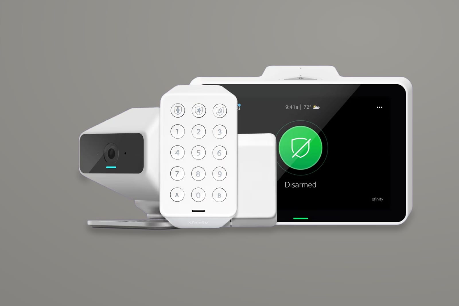The Xfinity Home device family on a neutral gray ground: camera, keypad, sensor, and the touchscreen showing the system disarmed